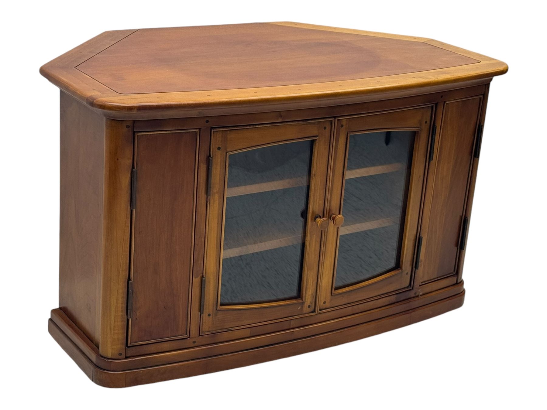Contemporary cherry wood corner TV unit, canted top over central glazed double doors opening to shelves for media storage, flanked by side storage compartments, on a plinth base