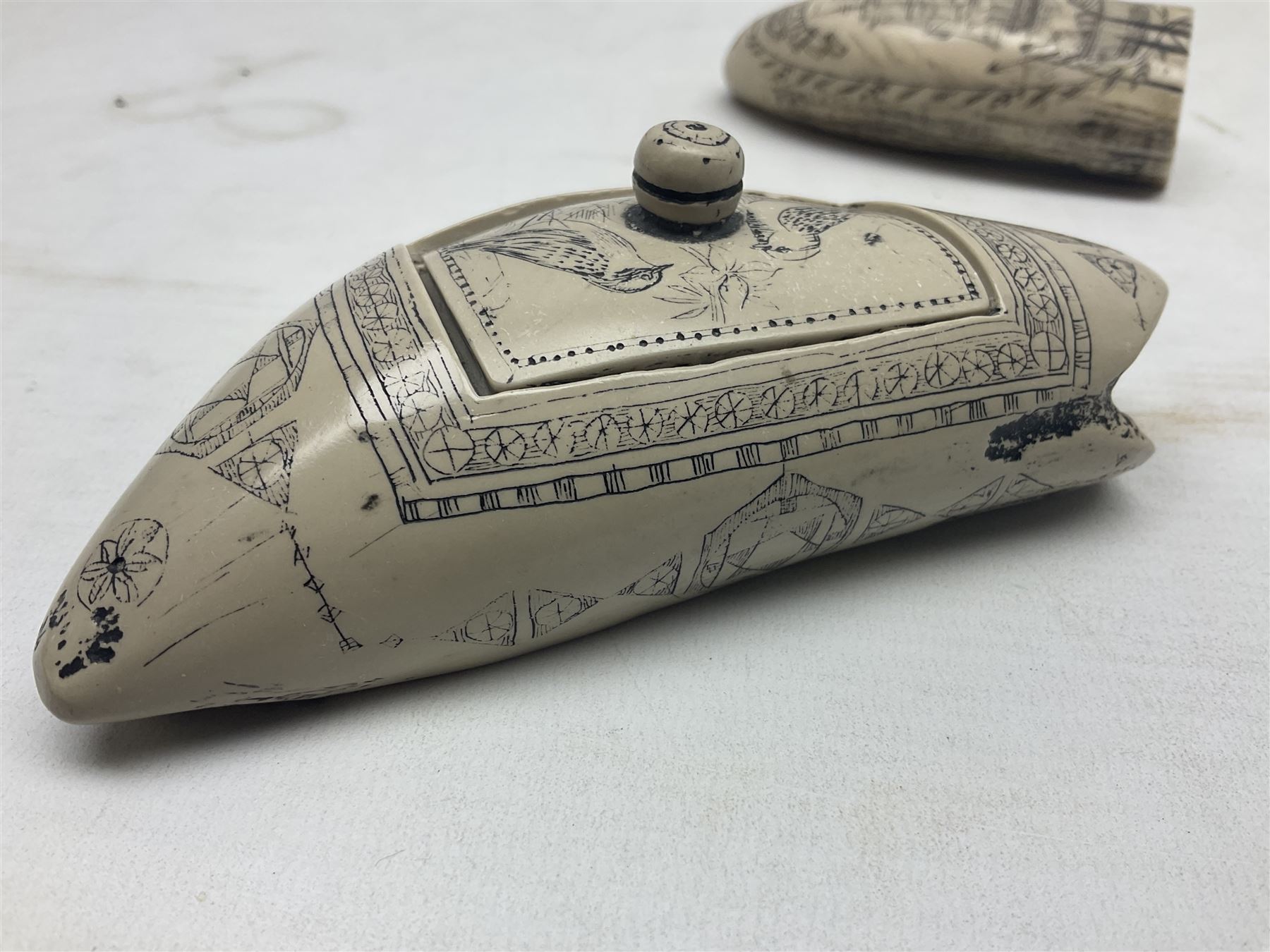 20th century resin carvings in the style of scrimshaws the first example depicting Ship Mercury, the other with a removable top, tallest example H10.5cm