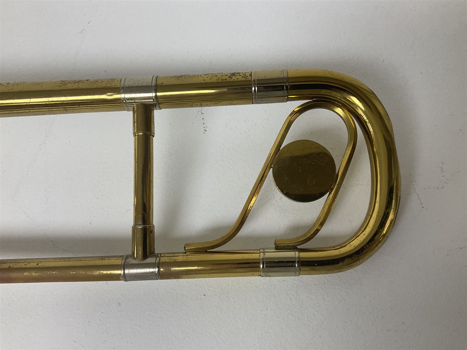Three brass trombones comprising Elkhart Ind. USA 'CONN' model no.72H; Besson 'Concord'; and Selmer Distributed 'Lincoln'; two in carrying cases; and German B & M 'Champion' brass trumpet (4)
