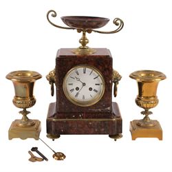 Neo-Classical red marble clock garniture, eight day movement, with urn top and lion mask h...
