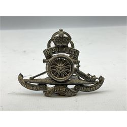 Trench Art - three WW2 brass shell case ashtrays, one mounted with Royal Artillery cap badge and button and one mounted with RA button; together with a pair of place name holders each formed from a Royal Artillery cap badge (5)