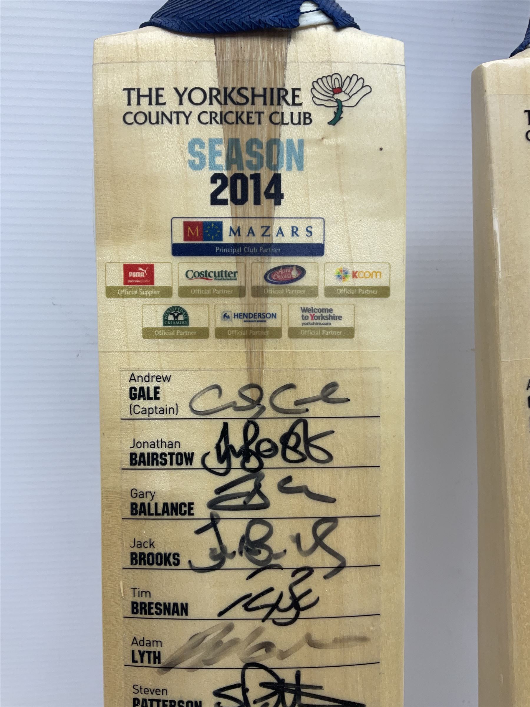 Two signed Yorkshire County cricket bats, from 2013 and 2014 seasons, bearing signatures including Johnny Bairstow, Joe Root, Tim Bresnan, Andrew Gale, etc