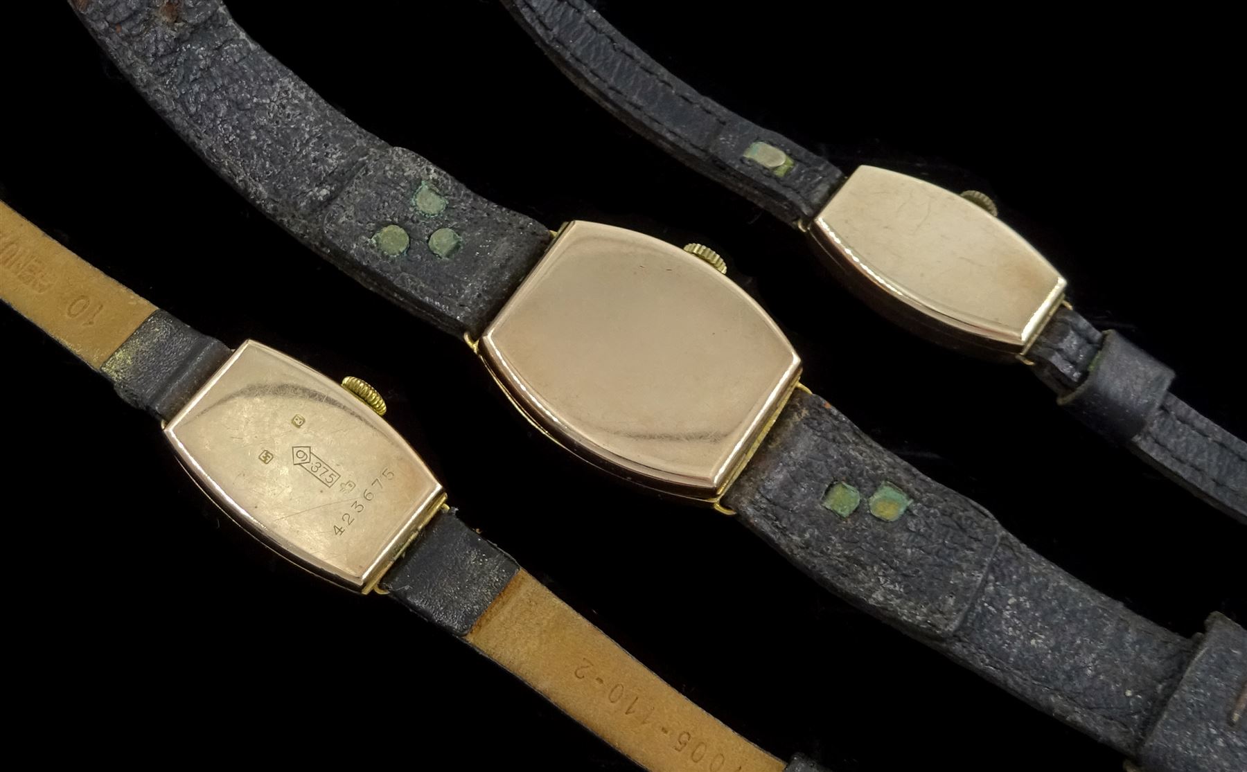 Three early 20th century 9ct gold, manual wind wristwatches, with cream and silvered dials, hallmarked, on leather straps