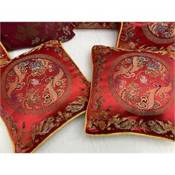Collection of predominantly Chinese style cushions, to include feather down examples