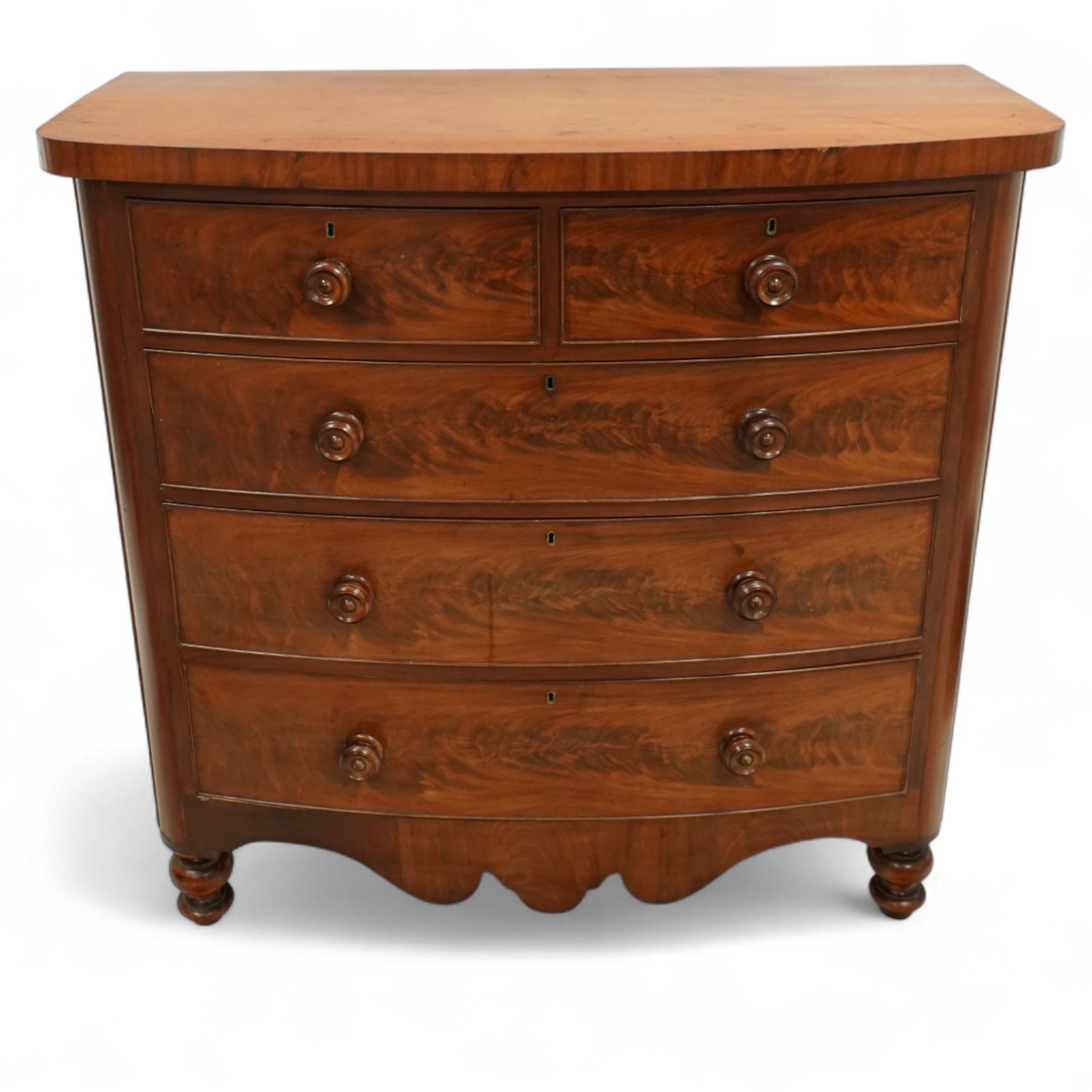 19th century mahogany bow front chest, with figured drawer fronts comprising two short over three long drawers, all with turned handles, shaped lower frieze and raised on turned supports