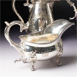 Pair of large silver plated sauce boats with bead edge decoration and C scroll handles engraved with a crest in the form of a winged heart and on shaped supports L20cm Maker probably Hawksworth Eyre & Co and an engraved hot water jug and a matching smaller jug with the same crest and by the same maker