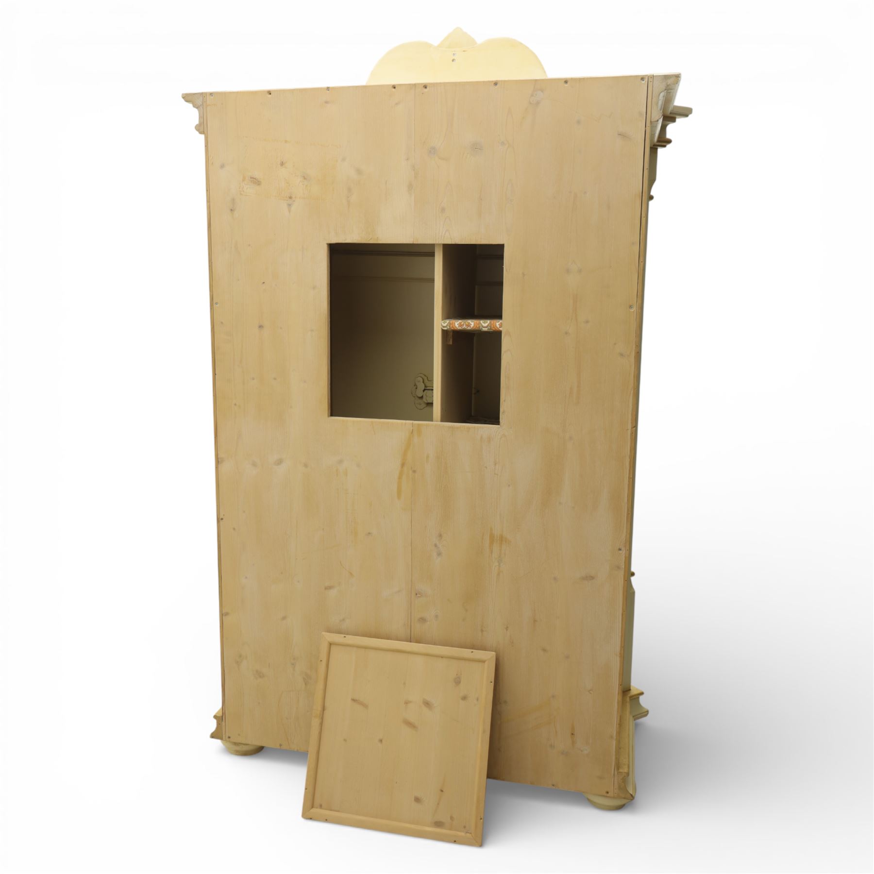 20th century French white and parcel gilt painted armoire, the shaped and scroll moulded cornice centred with a stylised foliate, the double doors with raised panel reserves applied with gilt foliate scrollwork, flanked by fluted pilasters with floral capitals, opening to a fitted interior with shelving and hanging space, raised on a moulded plinth on squat bun feet