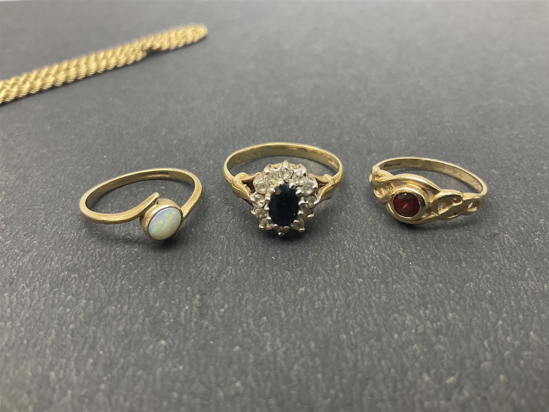 9ct gold jewellery, including opal ring and two other stone set rings, locket and rope twist chain 