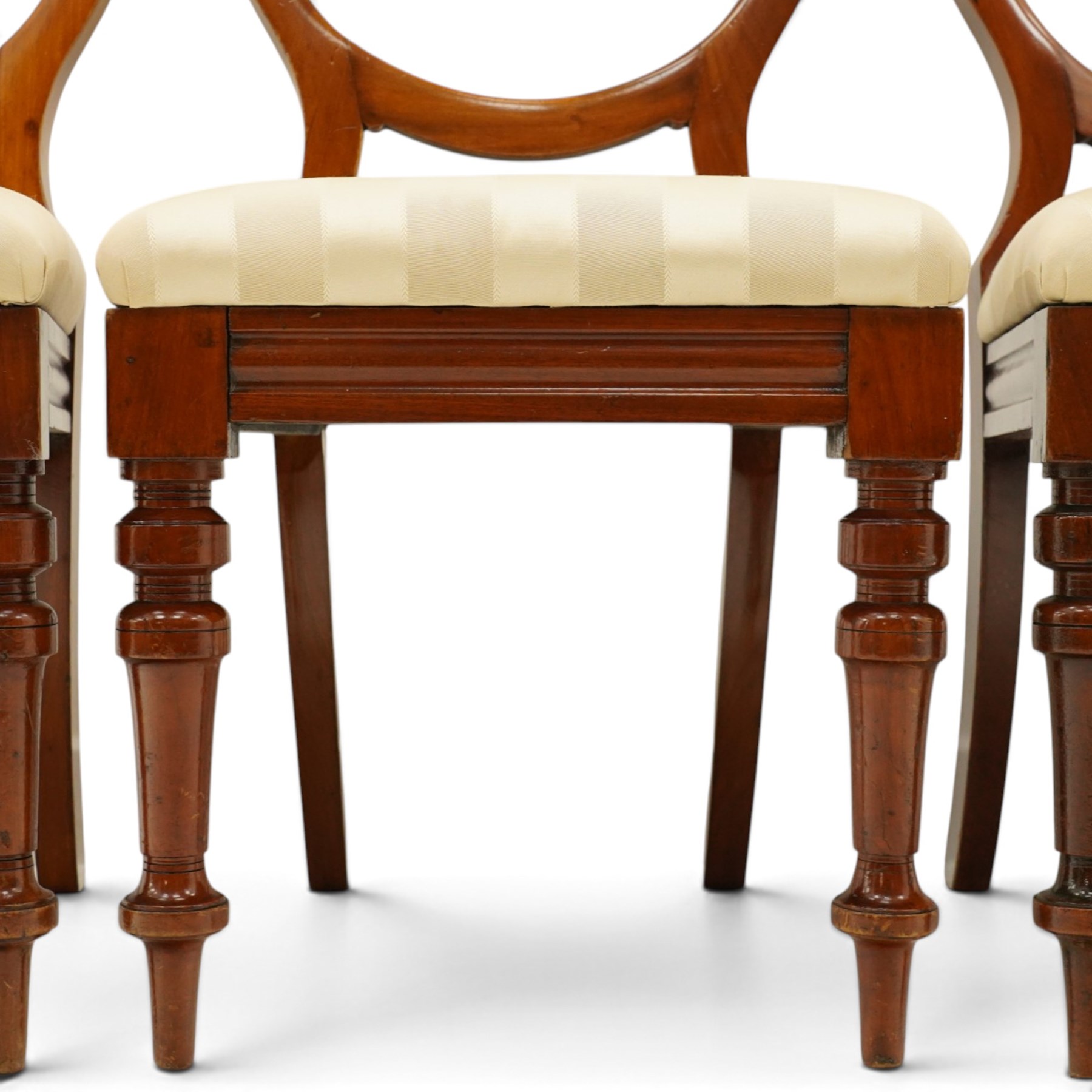 Set of twelve Victorian walnut balloon-back dining chairs, shaped open back over seats upholstered in striped ivory fabric, moulded seat rail above turned and tapering suppors