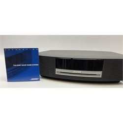 A Bose Wave music system, model AWRCC5, with remote control. 