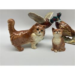 A collection of Beswick figures, comprising ginger cat model no 1898, ginger Persian kitten model no 1886, pheasant in flight model no 849, and pheasant model no 1226b.  