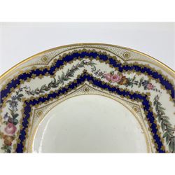 Sèvres soft paste porcelain coffee can and saucer with date code for 1767, painted with floral and laurel leaf garlands within blue scalloped and gilt borders, interlaced LL monogram enclosing the date letter O above painters mark for Catrice, coffee can H7.5cm, saucer D15cm
