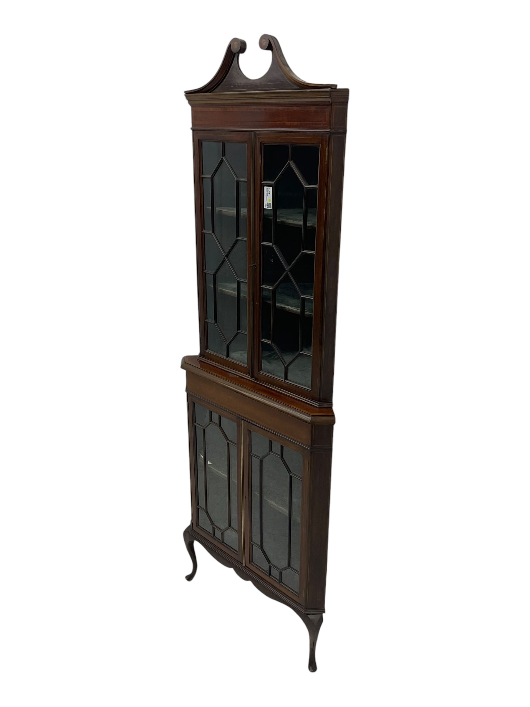 Edwardian mahogany corner display cabinet, scrolled swan neck pediment over astragal glazed doors, fabric lined interior, on cabriole feet 