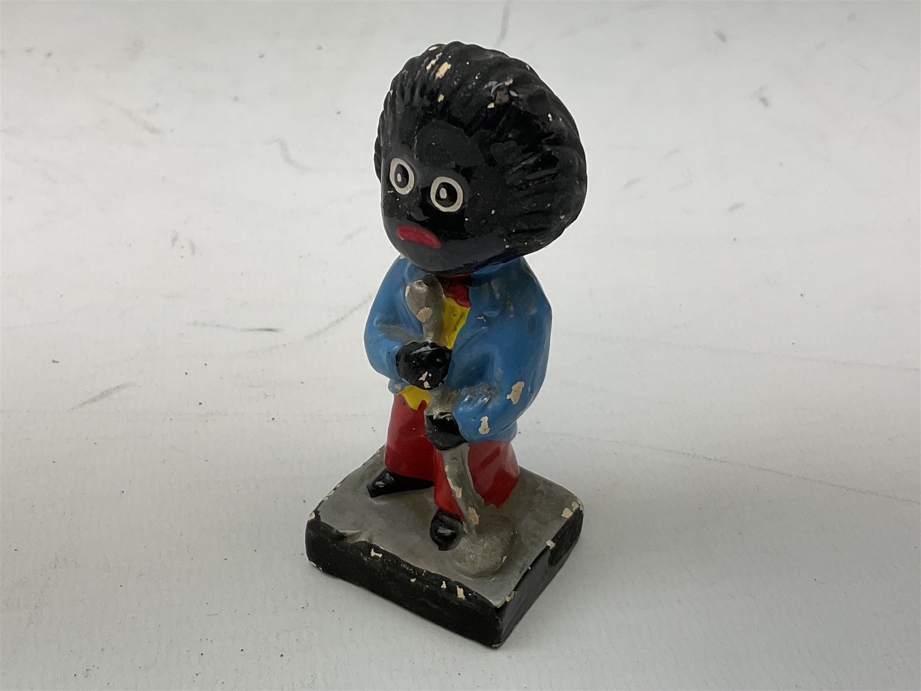 Robinson Jam plaster Golly band, including drummer and singer, H7.5cm

Originally handmade by mothers in Africa for their children from old fabric and cloth, the golly doll was adopted as the mascot and trademark for the Robertson's confectionery brand around 1910 after the company's founder John Robertson visited the US and noticed children playing with them. Robertson's Gollies have been collected by people across the UK and around the world for generations but garnered a contentious image in the 1980s because of links to racism. The trademark was removed from Robertson's branding in 2001.
