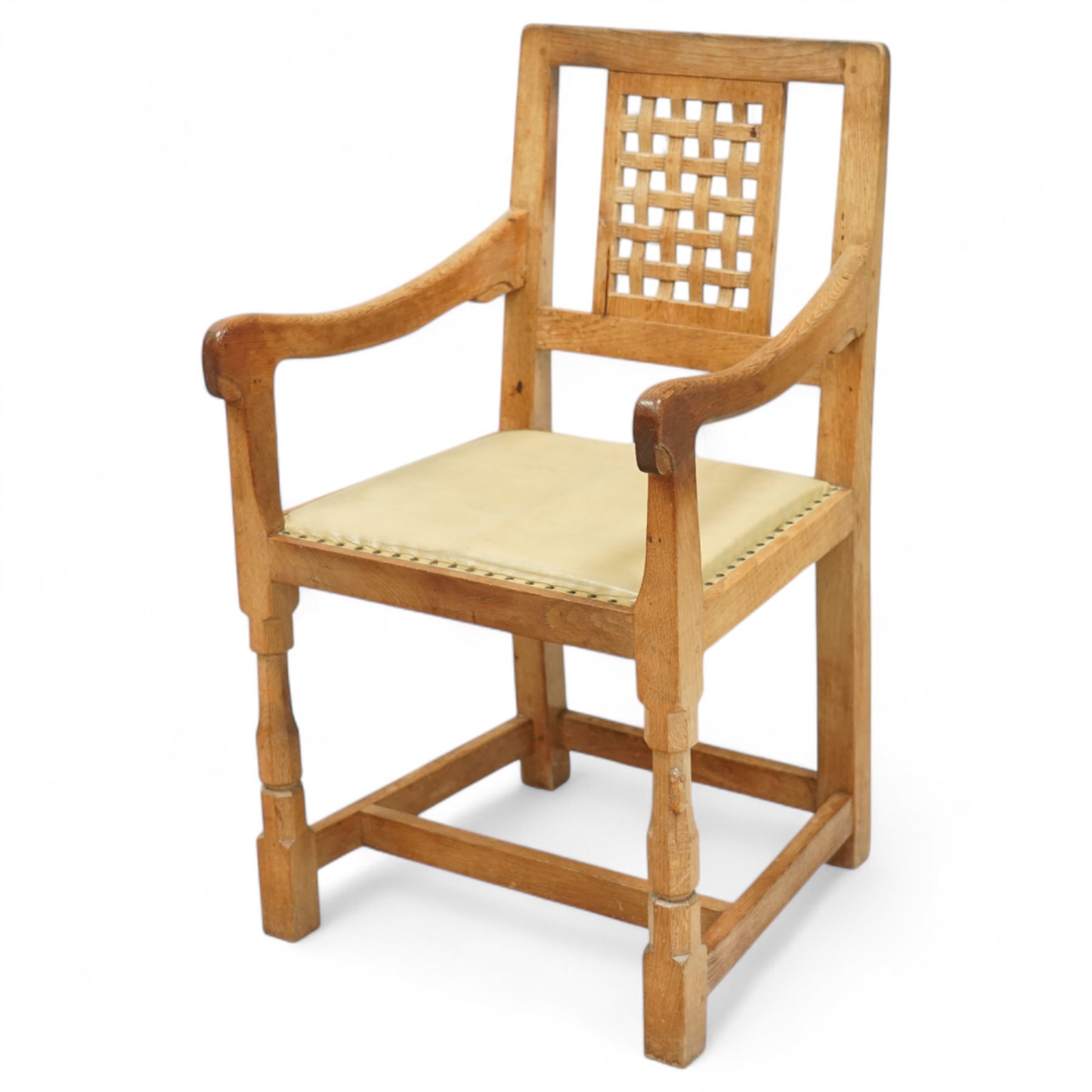 Mouseman - set of eight (7 + 1) oak dining chairs, pierced and carved lattice back over leather upholstered seat, on octagonal front supports united by stretchers, carved with mouse signature, by the workshop of Robert Thompson, Kilburn