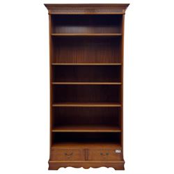 Ian Smith Furniture - Georgian design walnut open bookcase, projecting cornice over pierced geometric frieze, fitted with three adjustable fluted shelves above two drawers, on shaped plinth base 