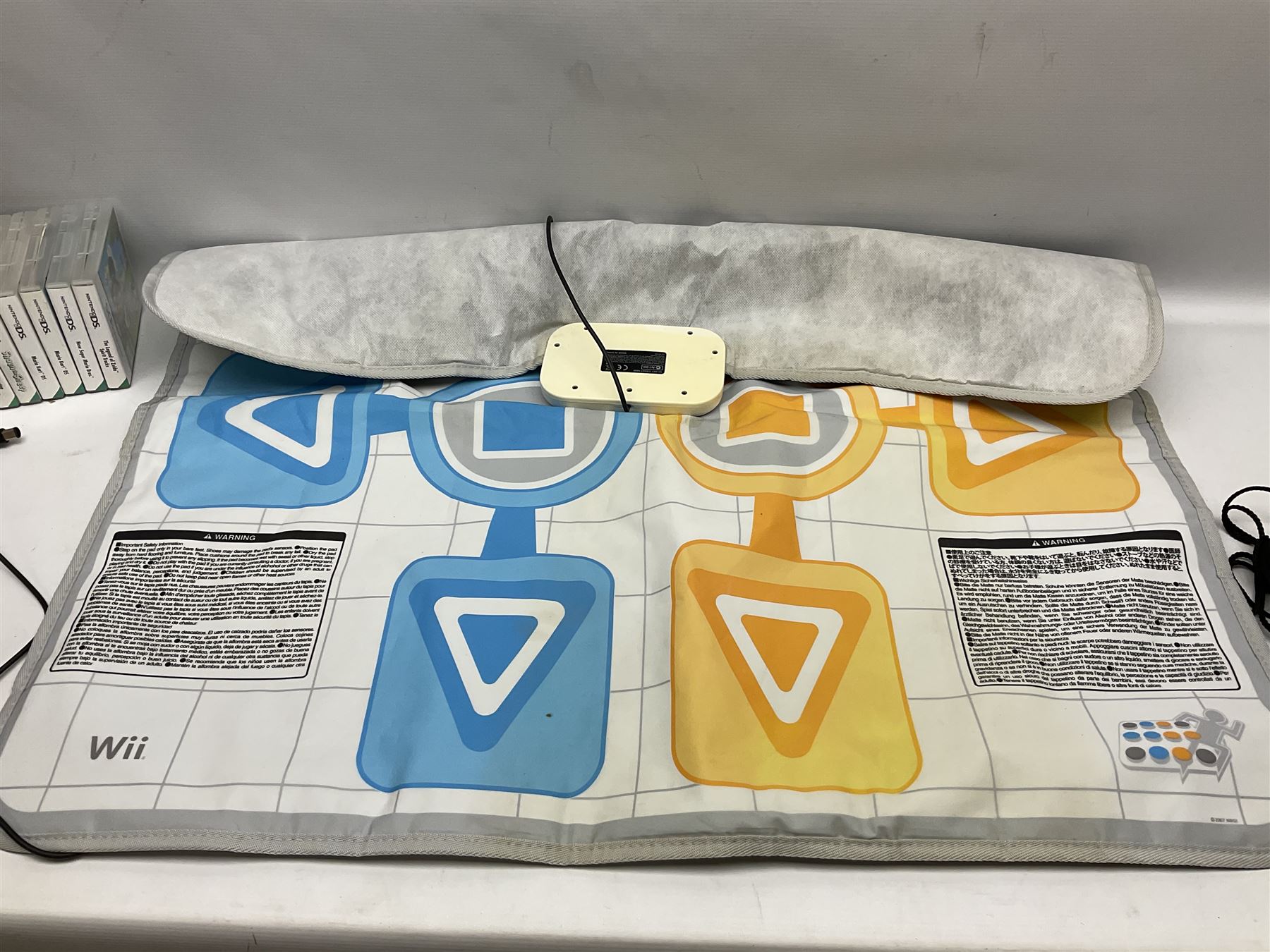 Nintendo Wii console, four controllers with cases and four nunchucks, Wii sensor bar, balance board and dance mat. Guitar hero wireless guitar for Wii and Redoctane wired guitar. Nintendo DS lite handheld gaming console, console and game cases and Guitar Hero Redoctane Guitar Grip. Selection of Nintendo Wii and Nintendo DS lite games to include Super Mario Galaxy, Guitar Hero, Wii Fit, Legend of Zelda games etc. Archos AV400 Series pocket video recorder with accessories, cradle and remote, in three boxes