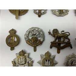 Twenty cap badges including Hertfordshire, Royal Sussex, Cambridgeshire, Hampshire, Notts and Derby, East Surrey, Herefordshire, South Lancashire, Devonshire, Bedfordshire, Durham Light Infantry etc (20)