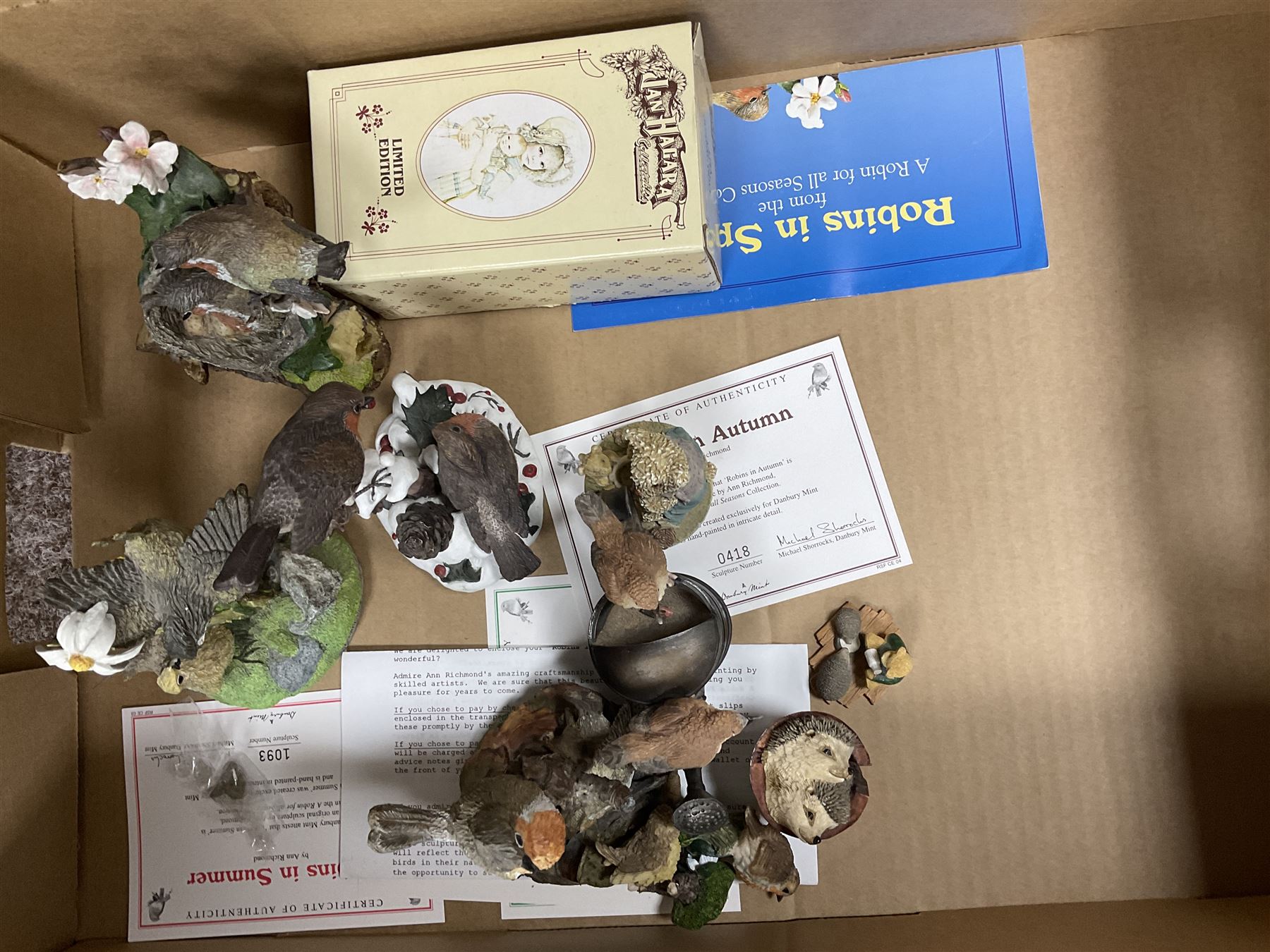 Swarovski crystal figures, together with glass display case, Danbury mint figures etc, in two boxes 