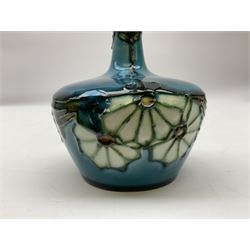 Minton Secessionist vase, with tube-lined stylised flower decoration, upon a blue ground, with printed mark to base 'Minton Ltd, No. 32', H13cm