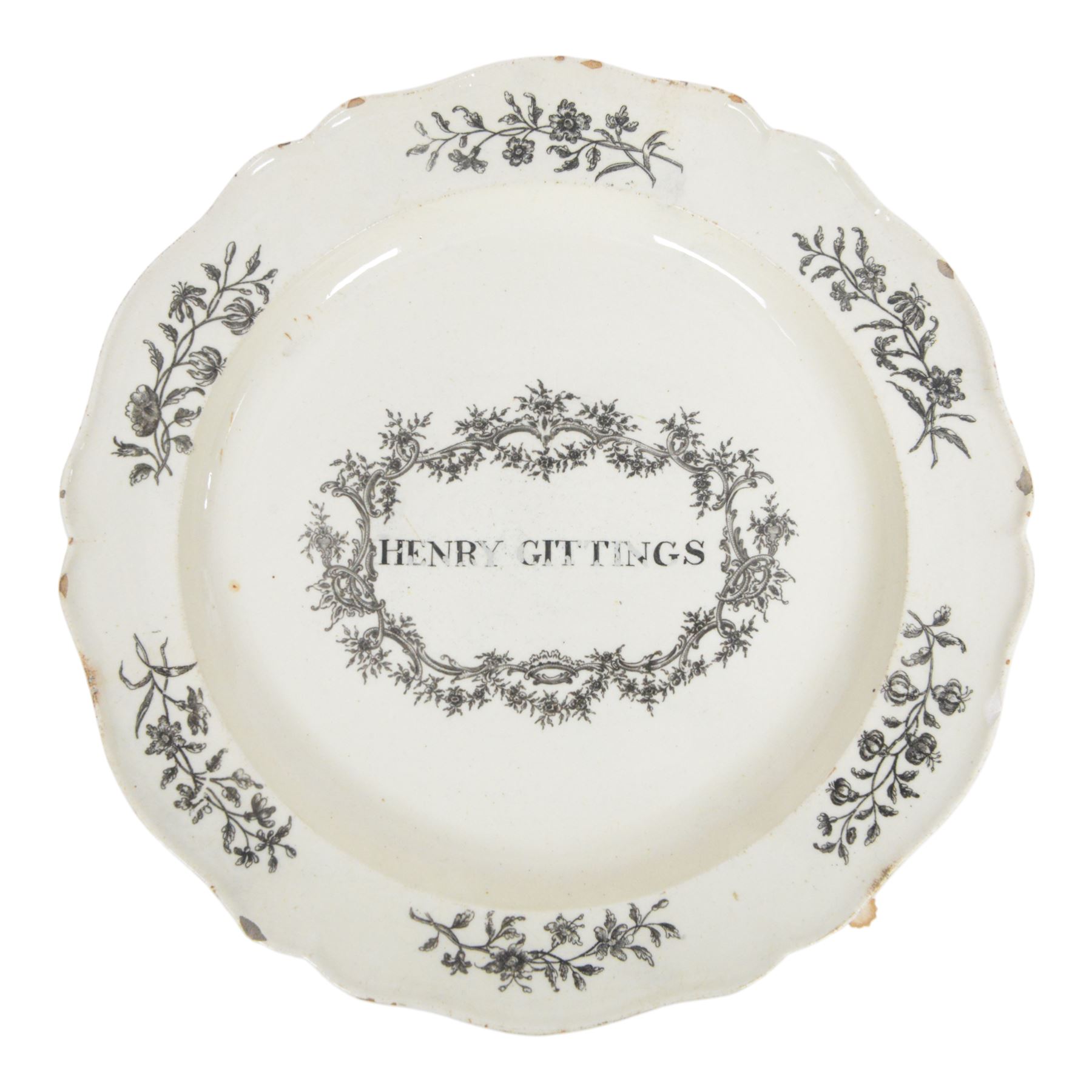 Late 18th century named creamware plate with black printed decoration, of circular form with shaped rim, inscribed to the centre 'Henry Gittings' within a foliate a C scroll surround, the rim detailed with floral sprigs, D24cm