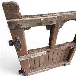 Pair of 19th century weathered wooden ecclesiastical church gates, the cresting rail over four pierced arches with slatted lower section, fitted with heavy cast iron hinges, latch and fittings