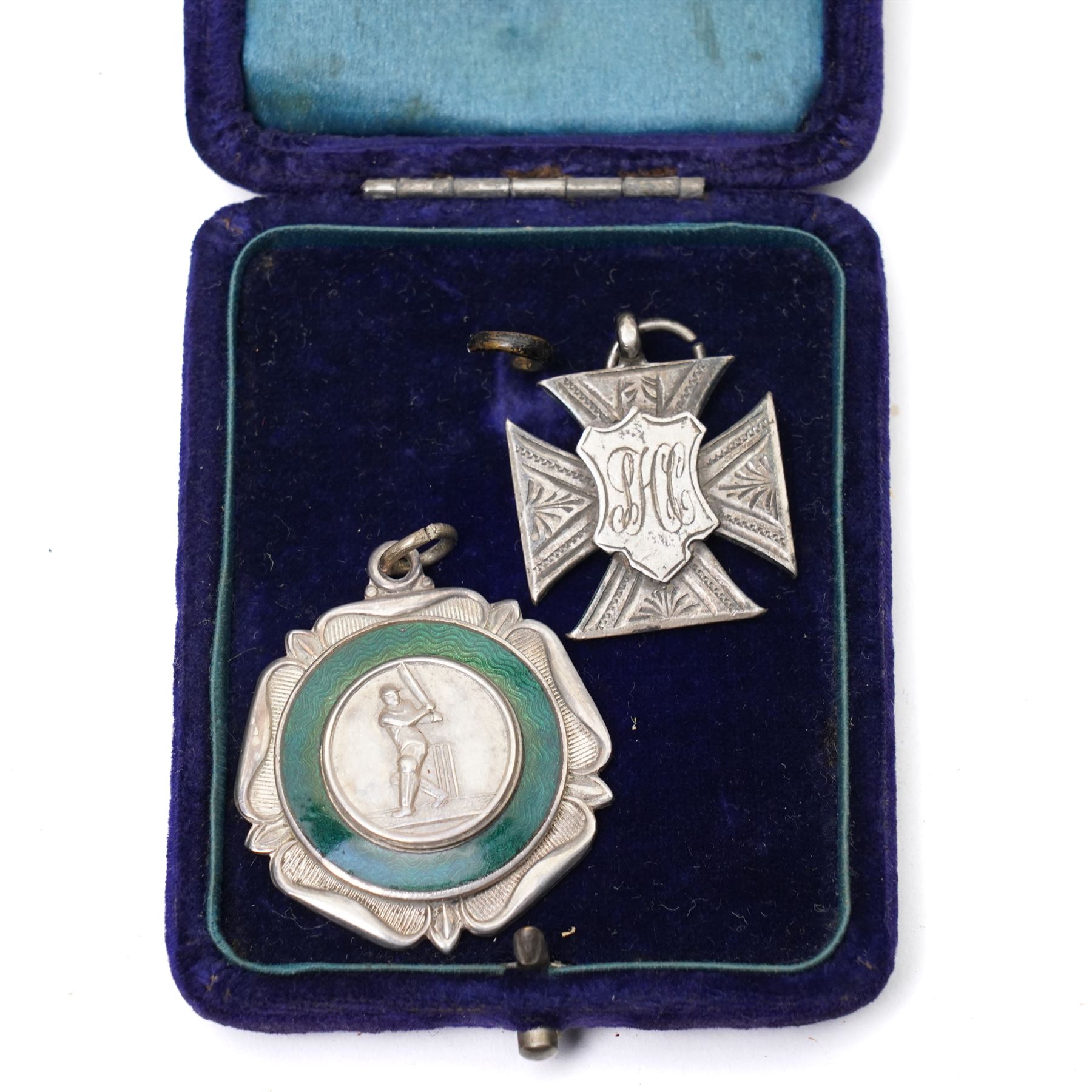 Group of early 20th century sporting medallions, fobs and badges, including two silver Inter Varsity 1/4 mile cased medallions, two silver fobs, white metal and enamel cricket fob etc, one awarded to John Barugh Fisher (1888-1924) born in Amotherby, studied at Leeds University and became doctor in 1911, later Captain John Barugh Fisher R.A.M.C., together with four early 20th century nurses badges, two for General Infirmary Leeds, three inscribed B.P. Simpson, housed in an inlaid work box