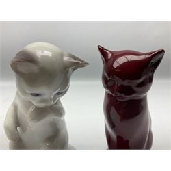 Royal Doulton flambé figure of a cat, together with a Bing and Grondahl Copenhagen model of a seated cat licking its paw, both with printed marks beneath, tallest example H13cm