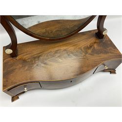 George III mahogany toilet mirror, the oval swing mirror upon curved supports with inlaid turned bone roundels, and serpentine fronted platform fitted with three draws, upon four bracket feet, H58cm W46cm D20cm