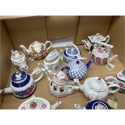 Twenty seven Porcelain Art miniature teapots, with wooden display together with a collection of other ceramics and glassware etc, including Goebel Hummel collectors plates, in three boxes,