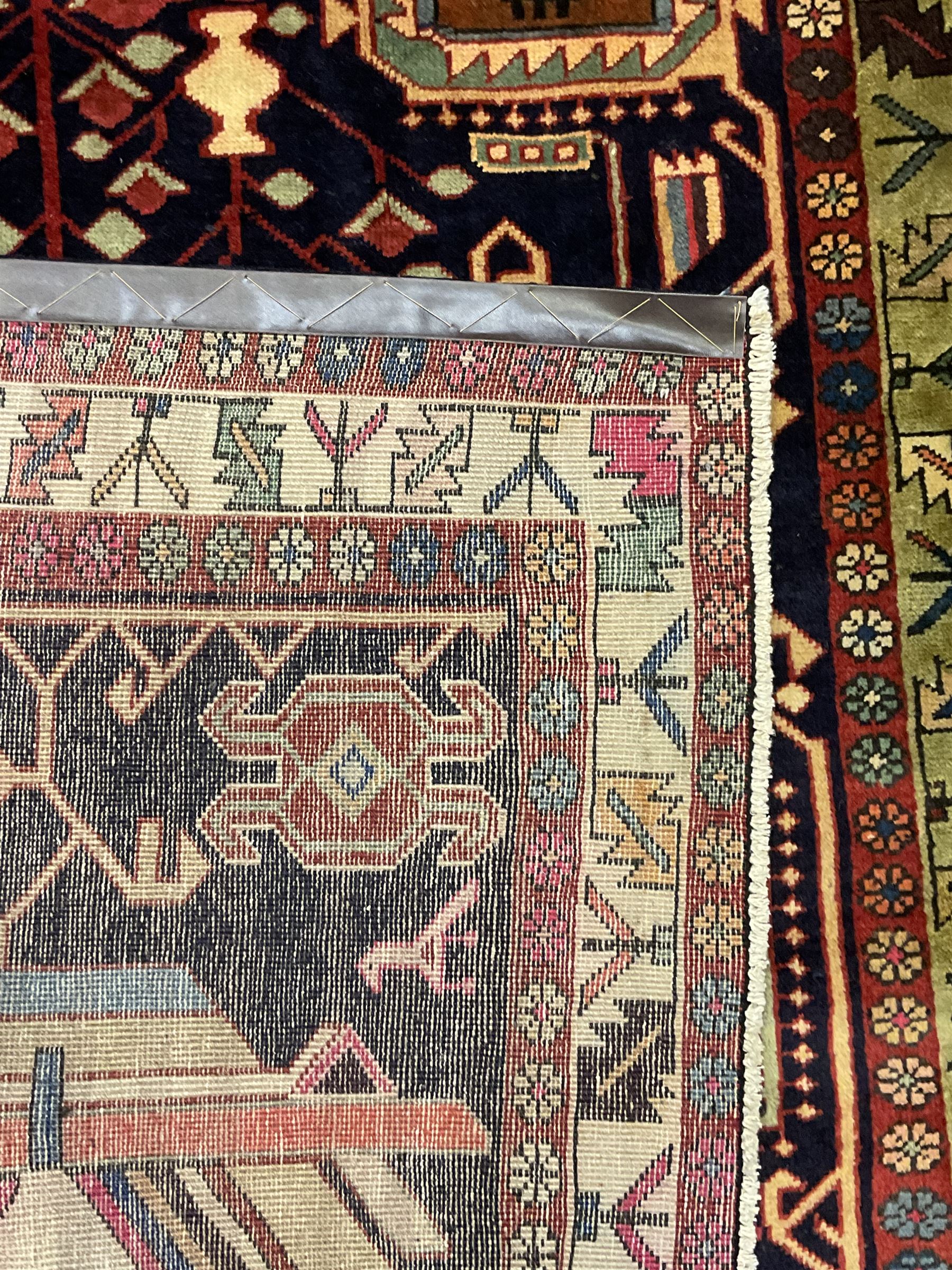 North West Persian Heriz Kelleh rug, the blue ground field with large stylised plant medallions, decorated with flower head, bird and tree of life motifs, triple band foliate pattern borders 