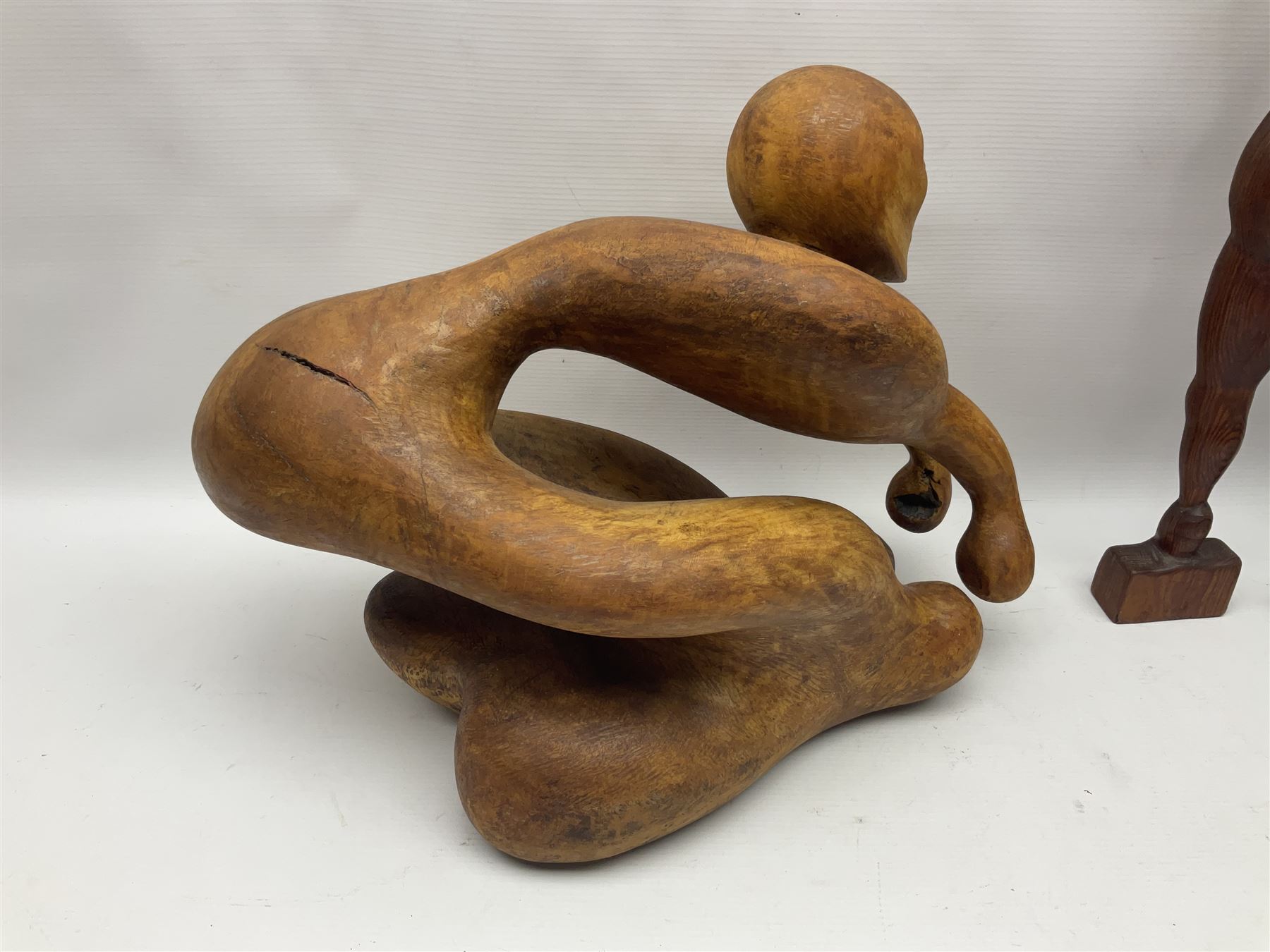 Helen Skelton (British 1933 – 2023): Three carved wooden abstract sculptures, each modelled as a a figure, tallest H52cm. Born into an RAF family in 1933 in Kent and travelled the world extensively during her childhood. After settling in Bridlington, Helen immersed herself in painting, textiles, and wood sculpture, often inspired by nature's beauty. Her talent was showcased in a one-woman show at Sewerby Hall and recognised with the sculpture prize at Ferens Art Gallery in 2000. Sadly, Helen’s daughter passed away from cancer in 2005. This loss inspired Helen to donate her sculptures to Marie Curie upon her passing in 2023.