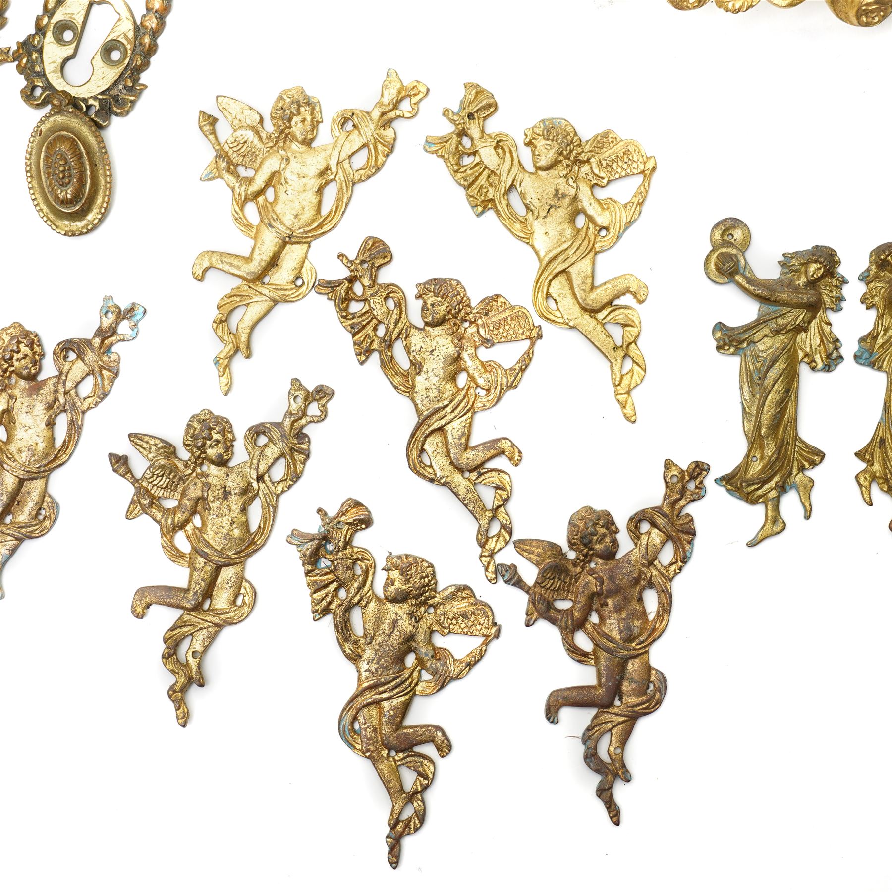 Victorian brass double key door plate by Thomas Elsley, possibly for a safe, three brass curtain tie backs formed as garlands, four brass cherub door plates marked 'H.V.' , four others similar and four others of female figures playing cymbals 
Provenance: property of a Nobleman