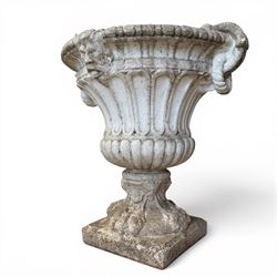 Pair of Neoclassical design cast stone garden urns, each of campana form with fluted body and gadrooned underbelly, decorated with faun/satyr opposing masks and ropetwist handles, with floral and mask design to the socles, raised on square bases, finished in weathered white patina