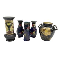 Pair of S Hancock and Sons Rubens Ware Pomegranate pattern vases of flattened baluster form, hand painted by F X Abraham, together with a similar cylindrical vase, together with a Bretby Art Nouveau stylised vase and Thomas Forester Art Nouveau stylised twin handled vase of ovoid form, all with stamped marks beneath, largest H23cm