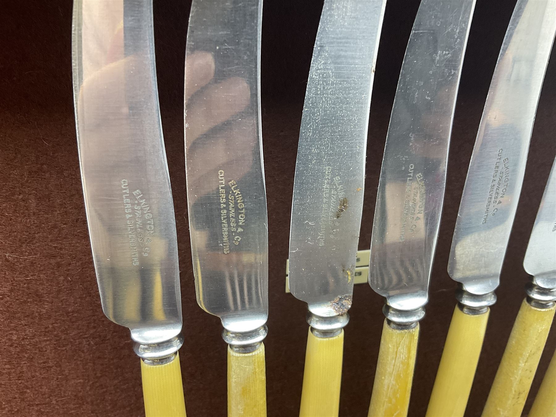 Elkington & Co part canteen of silver plated and stainless steel cutlery, to include simulated ivory handled examples, housed in oak and mahogany case, lock plate stamped 'Acme, British Made', W49cm D31cm H18cm