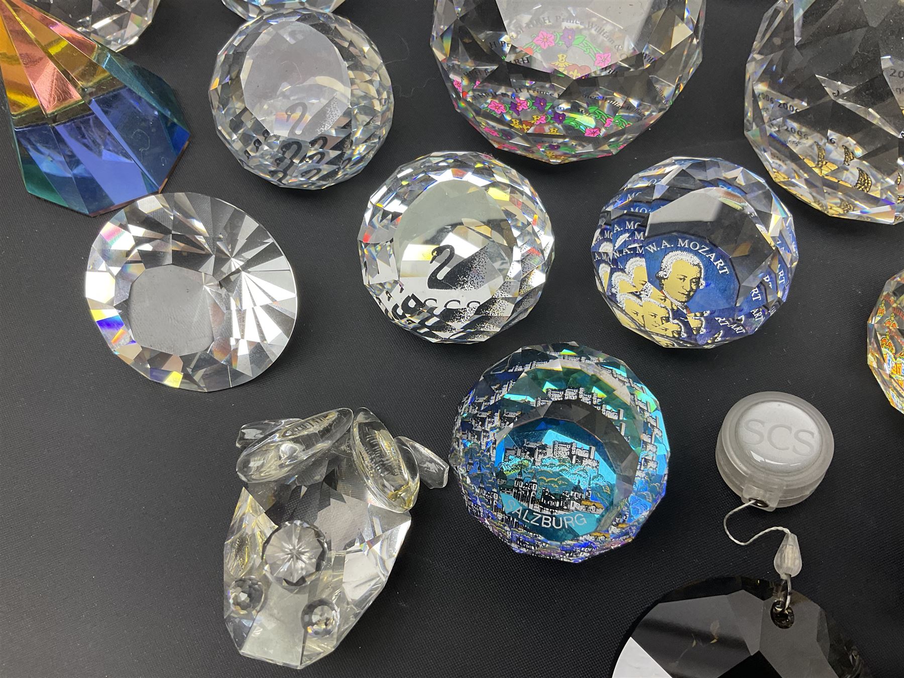 Swarovski Crystal paperweights, to include a globe with dove to the top, pyramid shapes etc, together with a large collection of boxes and stands  