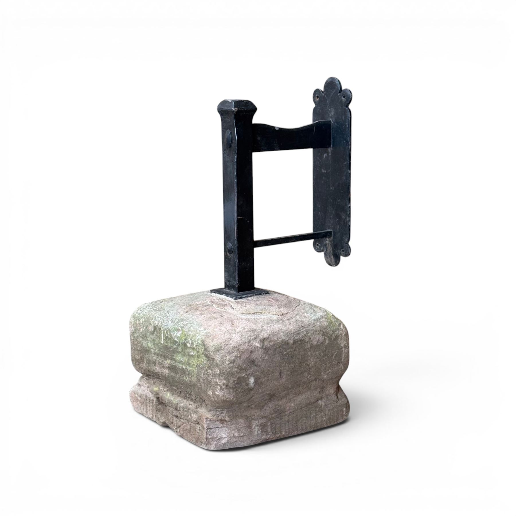 Large wrought metal boot scraper in black painted finish, set in formed stone plinth