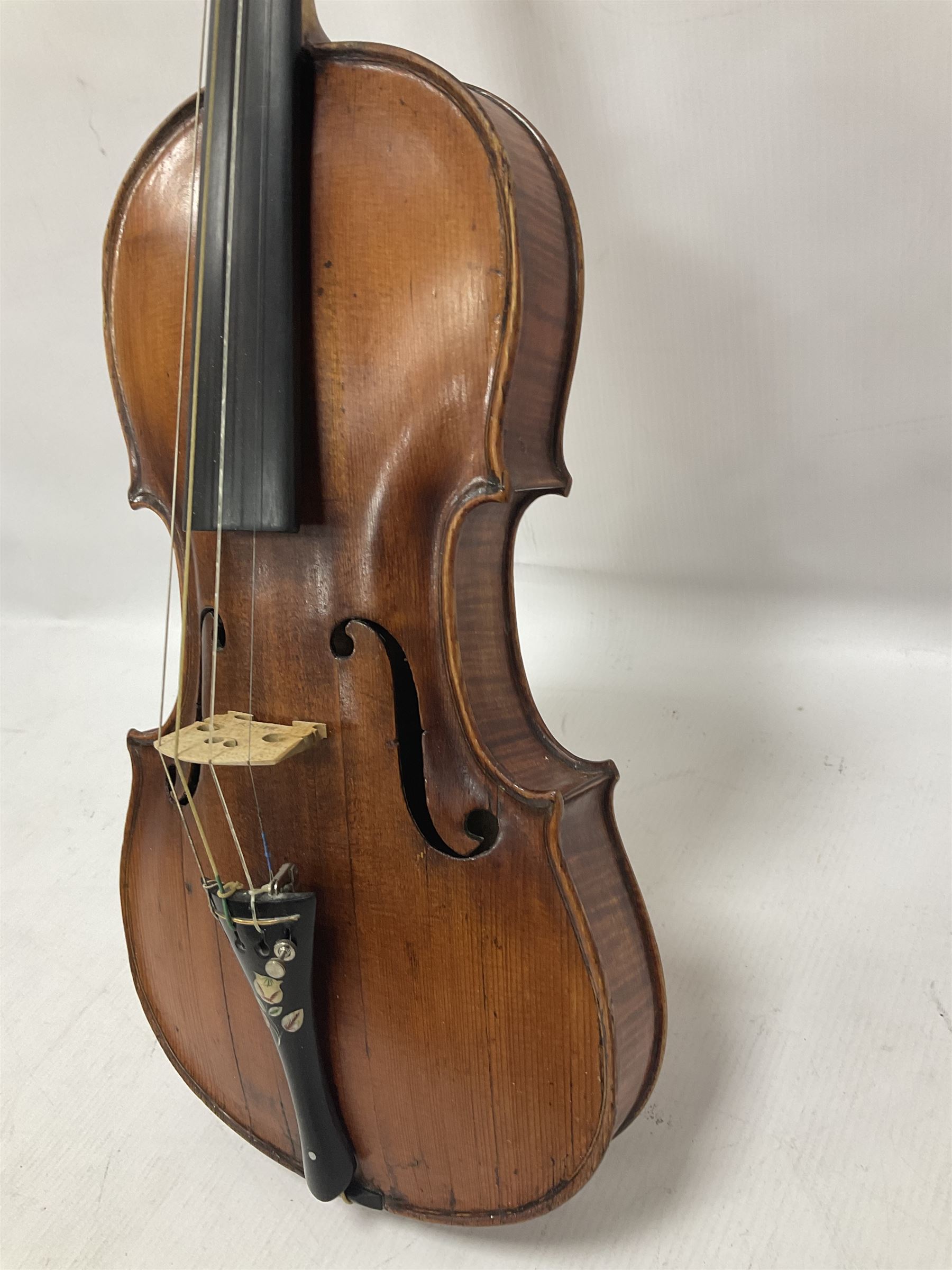 19th century full sized violin in a later hard case, decorative mother of pearl inlay to the tail piece Overall length 60cm No bow