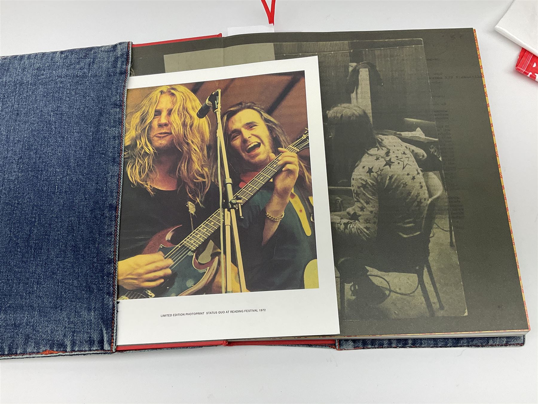 Status Quo: The Official 40th Anniversary Limited Edition book No.926/3000 with certificate signed by Rossi and Parfitt. Duplicate signatures by Rossi and Parfitt on pages within the book. Denim dustjacket; 'From The Makers Of ....' boxed set of three LP records in circular blue tin; and quantity of tour carrier bags