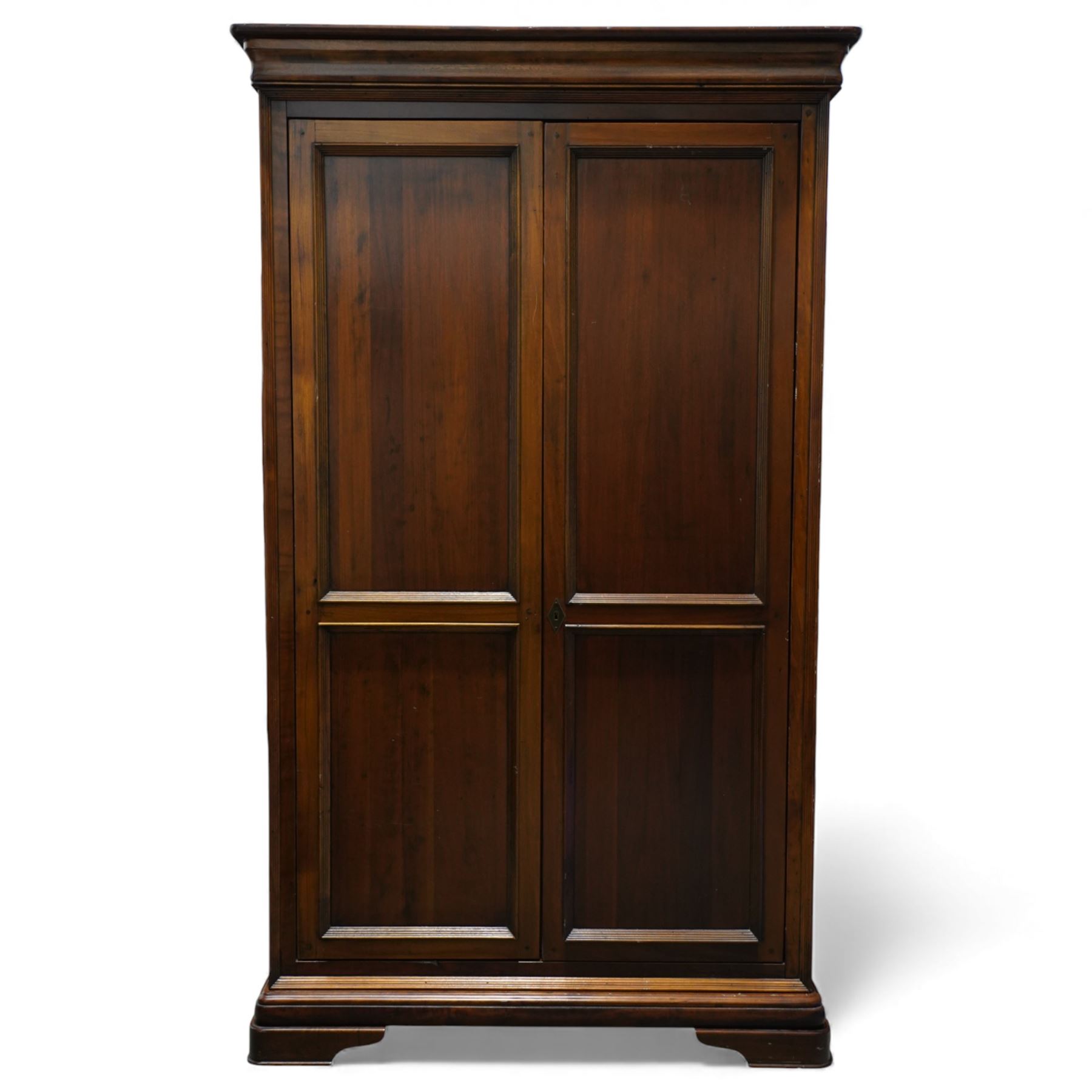 Willis & Gambier - French cherry wood double wardrobe, panelled front twin doors, internal wooden hanging rail below a shelf, raised on a moulded plinth base 