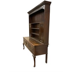 19th century oak dresser, projecting cornice over foliate carved frieze, the three-tier plate rack fitted with panelled cupboards to either side, base with central cupboard flanked by two drawers, raised on cabriole supports carved with acanthus leaves