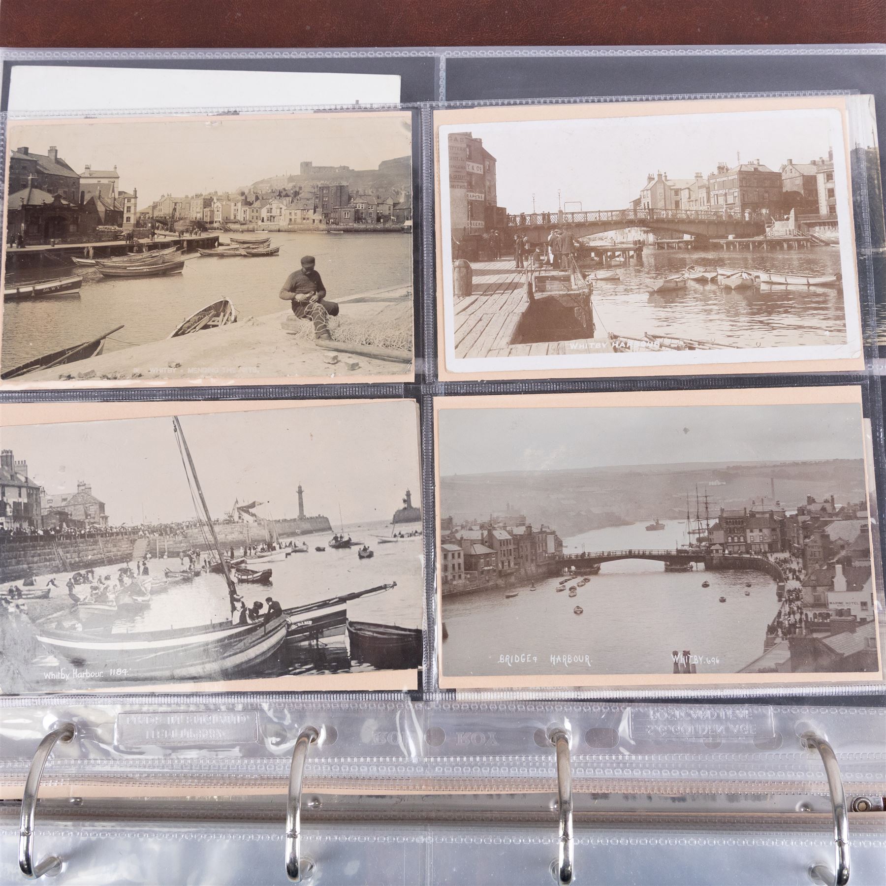 Two-hundred and thirty eight early 19th century to 20th century Whitby view postcards, including twenty-four early 19th century court cards, seventeen views of Whitby Abbey, forty depicting the fishing fleet and harbour, with a selection of cards providing a detailed study of the early 'Yards' the fisherman's dwellings around the harbour, all housed within a Stanley Gibbons Picture Postcard Album