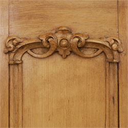 Late 19th century pine wardrobe, with stepped cornice over triple panelled doors, applied foliate carvings to outer panels, raised over a separate pine plinth drawer with moulded facia and twin glass pulls
