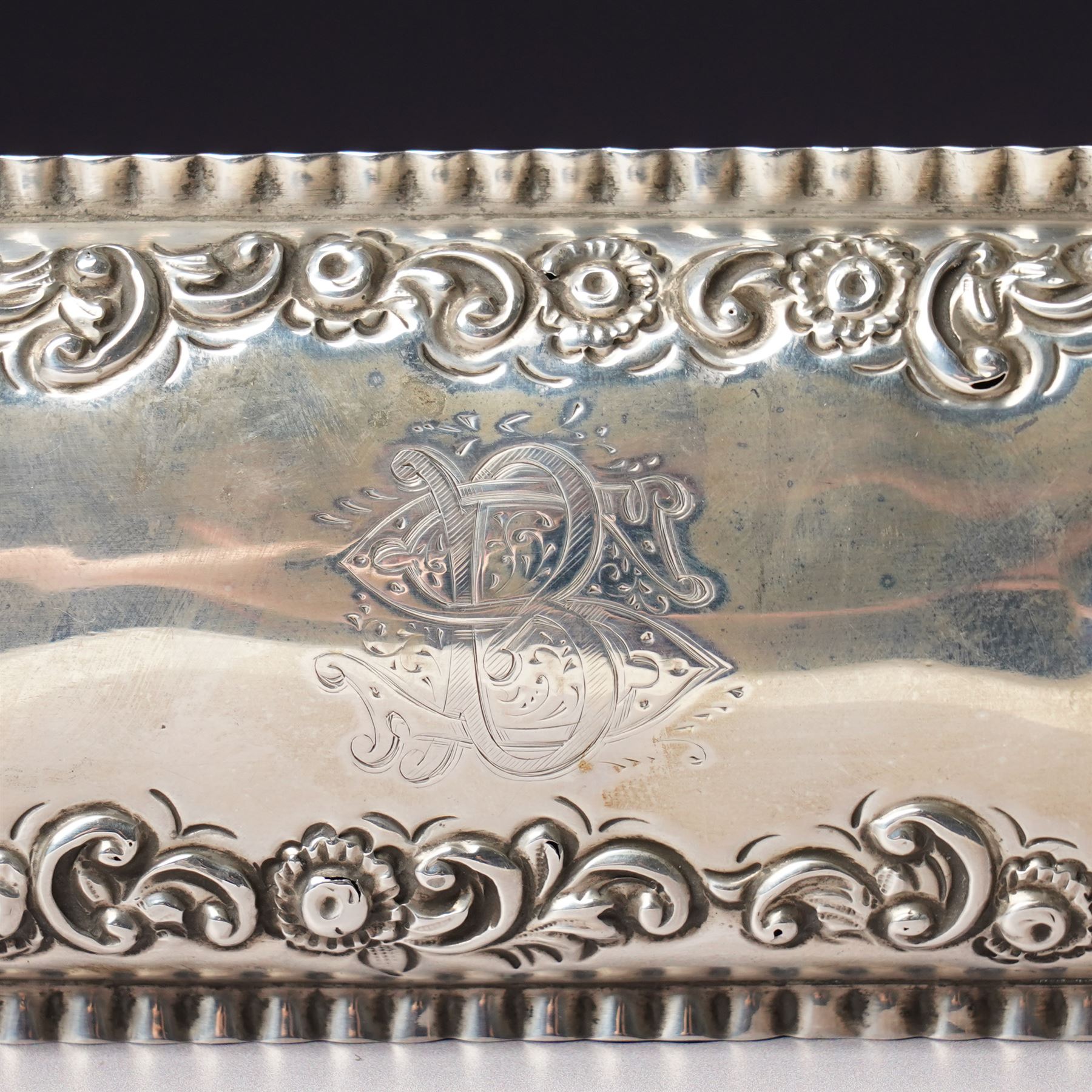 Late Victorian silver dressing table box of rectangular form with embossed hinged lid and engraved with a monogram with crimped border W15.5cm Chester 1896 Maker King & Sons