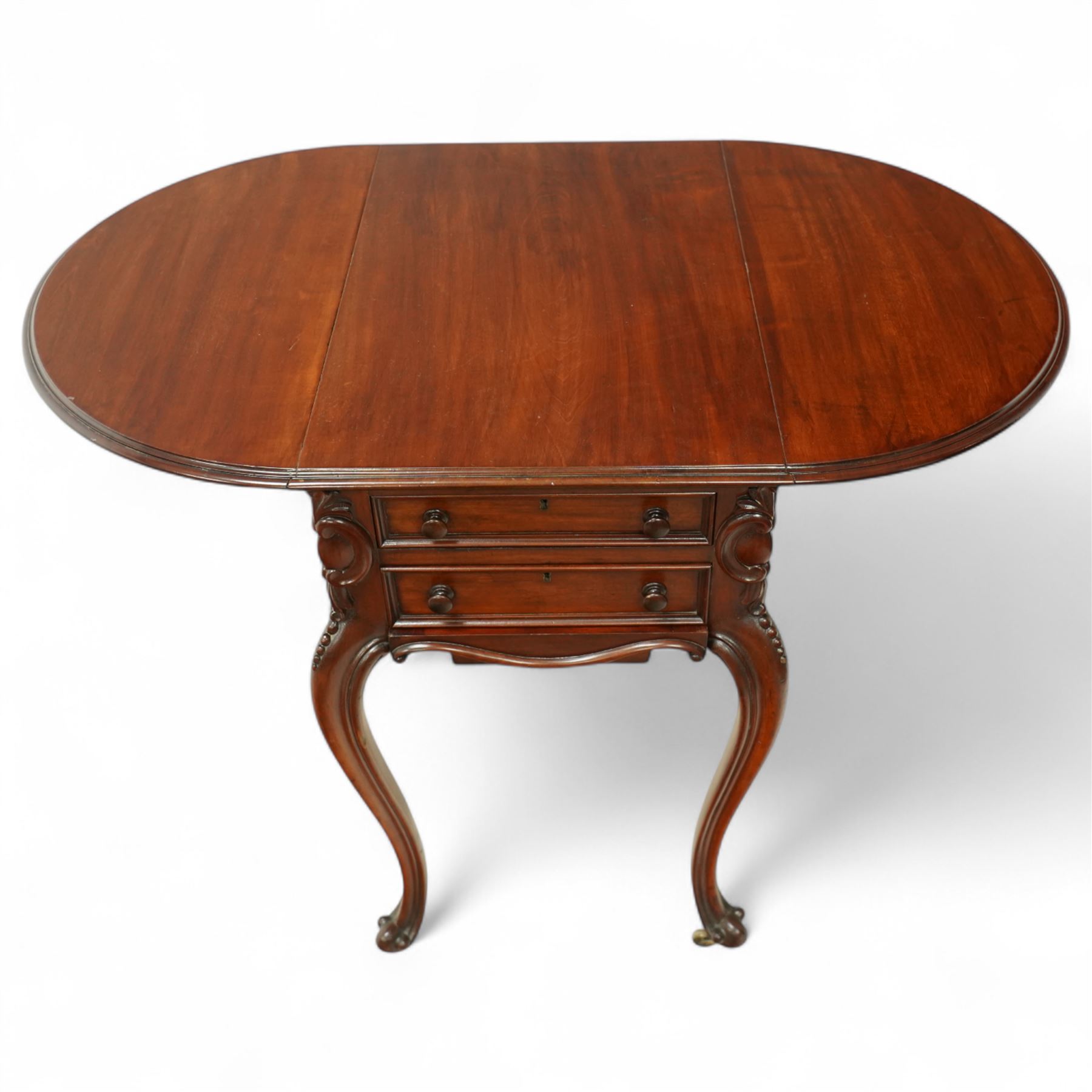 Victorian mahogany drop-leaf work table, the rectangular top with rounded hinged leaves above a bank of three drawers and opposing dummy drawers, fitted with a sliding work box, carved scroll and foliate knees, on cabriole supports with brass castors