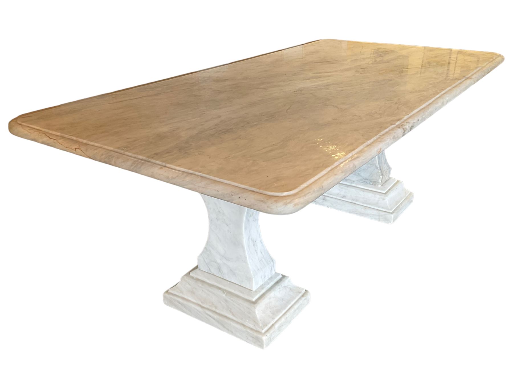Classical Grecian design Carrera marble centre table, the rectangular single slab top with rounded corners and carved edge, raised on twin pedestals comprised of three pieces with a waisted column on a stepped plinth
