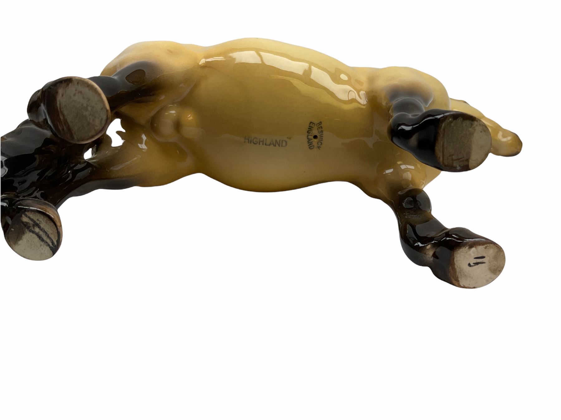 Beswick horse figures, comprising Highland Pony 1644, and another, probably Aran Bahram in grey, each with printed mark beneath.
