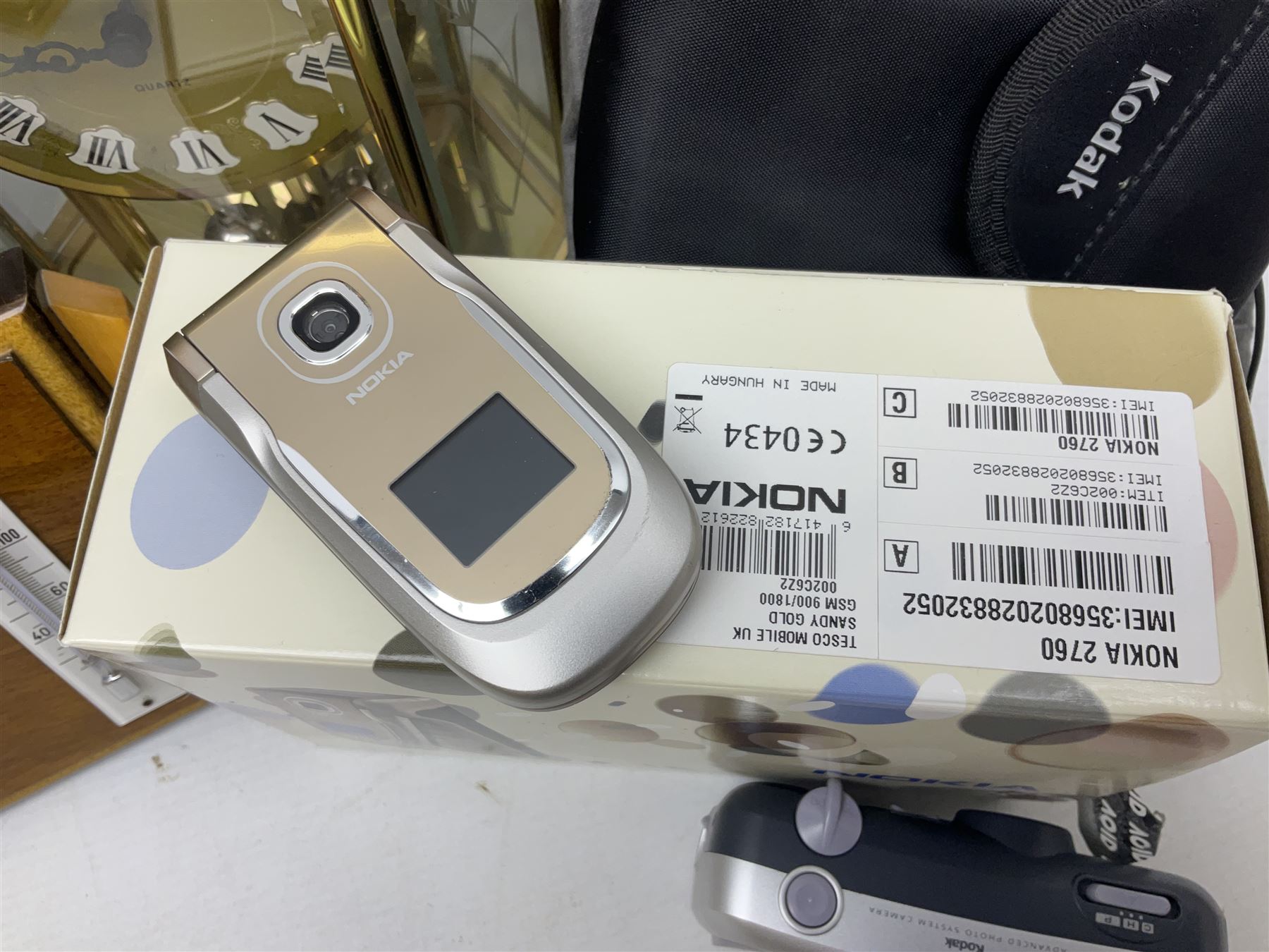 Kundo quartz clock, miniature brass clocks, two barometers, Sony digital camera, Nokia phone, Monarch Remington typewriter, commemorative Shilling etc