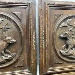 Pair of oak furniture door panels, carved in relief with a fox to one and a hound to the other, together with a pair of smaller oak panels, carved in relief with a hare to one and a grouse to the other, doors W63.cm x H62cm, panels W43cm x H60cm